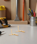 Dope 92 Degree Quadrant Hinges in gold iron on a workshop table, 8-hole design, ideal for wooden boxes and cabinets