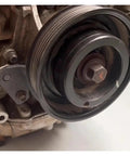 Close-up of an engine component featuring a camshaft pulley with locking tool attachment for Pro Level Camshaft Alignment Locking Timing Tool Kit For Volvo 1.5T 1.6T 2.0T 2.3T EcoBoost And Jaguar Land Rover Evoque 2.0T Heavy Duty Steel Engine Repair Set Built Tough For Shop Grade Performance.