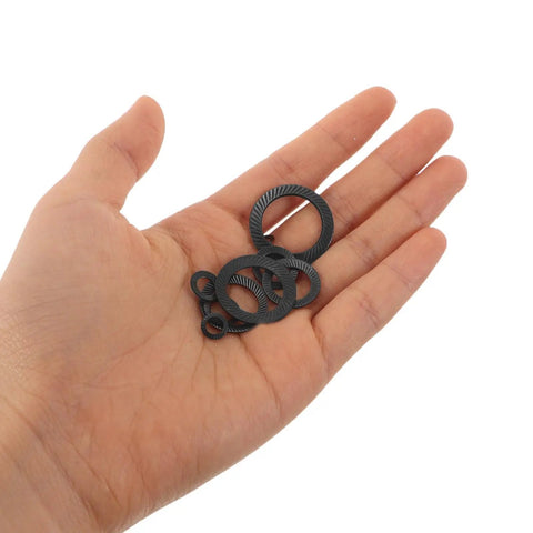 72 Piece Set Double Tooth Lock Washers Black Ironclad Grip 65mn Steel in hand, showcasing various sizes for secure fastening.