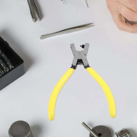 Heavy Duty Single Hole Punch Plier For Paper And Crafts shown with yellow handles on a workbench surrounded by tools.
