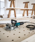 Plate Joiner For Quick, Precise Biscuit Joinery With Five Point Six Amp Motor And Eleven Thousand RPM, Cast Aluminum Pivot Fence With Zero, Forty Five, And Ninety Degree Stops, Six Depth Settings For Zero, Ten, And Twenty Biscuit Sizes on workbench
