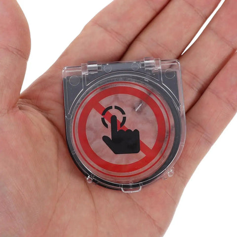 Transparent Push Button Switch Cover For Computers And Elevators held in hand, clear round design with anti-press symbol