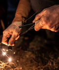 Person using 4 Pack Five Sixteenth Inch Ferro Rod Fire Starters With Wood Handles And Multi Tool Striker for outdoor fire making