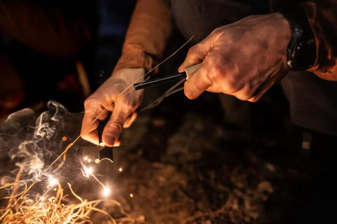 Person using 4 Pack Five Sixteenth Inch Ferro Rod Fire Starters With Wood Handles And Multi Tool Striker for outdoor fire making