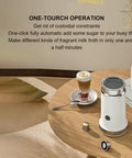 Fully Automatic Milk Frother For Hot Or Cold Foam, Electric Milk Warmer And Frother on wooden table with coffee cup
