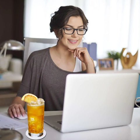 Woman using laptop with drink on 20 Pack Sublimation Coaster Blanks Set With Square And Round Cup Mats For DIY Heat Transfer Projects Perfect For Craft Folks