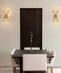 Dining room with Brass Mid Century Modern Wall Sconces Set Of 2, Brushed Brass Starburst Wall Lighting on either side of dark door.