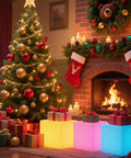 Lit RGB Color Changing LED Cube Seat 14-Inch LED Cube Chair With Remote near Christmas tree and fireplace in cozy room.