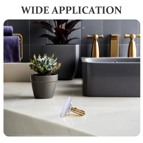 Copper Bathtub Drain Stopper with Bounce Design for Easy Control placed on countertop with plant and modern tub in background.