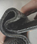 Close-up of Heavy Duty Torch On Asphalt Roof Sealant Roll, showcasing rolled black polyethylene underlayment tape for roof patching.