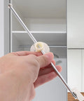 Hand holding part of 4 Pack Lid Support Hinges For Cabinet Doors With Motion Control Iron Build Round Base in kitchen setup