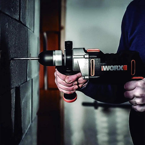 Knockout Impact Drill Packing 810 Watts And A Beefy 13 Mm Chuck Featuring Variable Speed Control in use on masonry wall.