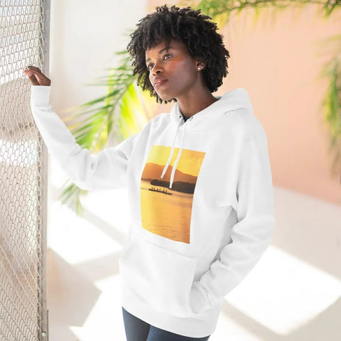 Woman wearing Outrigger Canoe Sunset Molokai Hawaii Inspired Three Panel Fleece Hoodie with soft cotton blend in sunny room