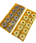 Carbide turning inserts WNMG431/432, 24 pieces in bronze and gray finishes, shown in two yellow trays.