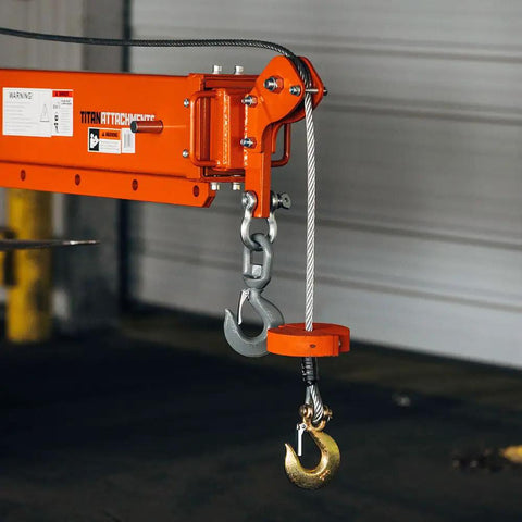 Heavy Duty Fork Mounted Jib Crane With Electric Winch Pivoting Telescopic Boom Extends To 138 Inches showing hook and cable.