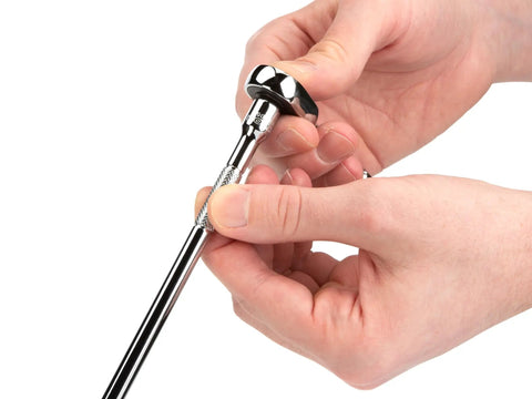 Hands holding Pro-Grade 1/4 Inch Drive 12-Point Socket And Ratchet Set 55-Piece Kit tool, showing ratchet detail.