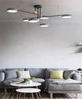 Sleek Modern 6 Head Sputnik Chandelier With Smooth 360 Degree Rotating Gold Pendant Light Top Notch Ceiling Fixture For Dining Room Bedroom Kitchen Setup Featuring Vintage Edison Socket above gray couch in living room.