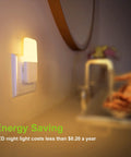 Plug In Night Light With Smart Dusk To Dawn Sensor illuminating a bathroom countertop, showing warm white LED glow, 2 pack