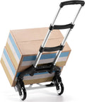 Folding telescoping hand truck with boxes, lightweight for travel.