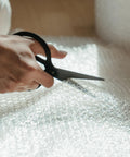 Thickened LDPE Bubble Wrap Roll for Moving and Shipping being cut with scissors, showing eco-friendly packing material detail.