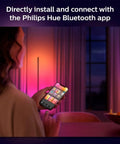 Person using smartphone to control Indoor 6-Foot Smart LED Light Strip Base Kit With Plug For Mood Lighting via app