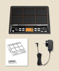 Percussion Sample Pad For Electric Drum Kit With 9 Velocity-Sensitive Pads, power adapter, and manual displayed on a beige background