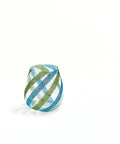 Decorative glass object wrapped in green and blue striped pattern against white background, suggesting creative craft use.