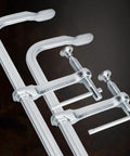 Close-up of Heavy Duty F Clamp with drop forged steel and adjustable rotating pad for welding and woodworking workhorse tasks