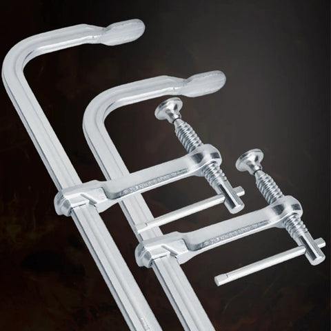 Close-up of Heavy Duty F Clamp with drop forged steel and adjustable rotating pad for welding and woodworking workhorse tasks