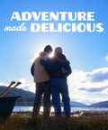 Two people embracing near a canoe by a lake with "Adventure made delicious" text above.