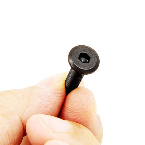Hand holding flat head socket screw from Ten Piece Baby Crib Bolts Replacement Hardware Kit M6 x 25mm for bed frames, chairs