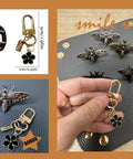 Front view of bee-shaped turn-lock purse hardware 5-piece set in dark metal with keychain charm for purses
