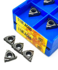 Carbide turning inserts for 11IR/11ER AG60 H01; gray triangular inserts with center hole in blue storage case.