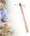 Man using Stainless Steel Garden Pickaxe Tool For Digging And Soil Cultivation with wooden handle on a log in a garden.
