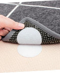Hand applying Ten Pairs Anti Curling Carpet Tape Keeps Rugs In Place Non Slip Adhesive For Carpets on a gray rug edge
