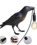Cool Crow Table Lamp With Resin Bird Design showcasing black crow holding LED bulb, E12 base, black finish, perfect decorative desk lamp.