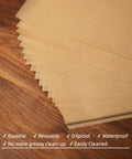 Heavy Duty 6X6 Inch Pre Cut Parchment Paper Squares 19200 Ct Bulk Case shown stacked on wood surface, durable and oilproof.