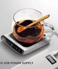 Smart USB Coffee Mug Warmer With Three Temp Settings Keeps Your Daily Brew Nice And Toasted Flat Bottom Heat Pad For Office Home Desk Warm Drink Setup with a glass cup on a heater.