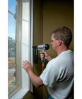 Man using 16-Gauge Straight Finish Nailer Kit With Tool-Free Depth-Of-Drive Adjustment, Jam Release, And Durable Motor on window trim
