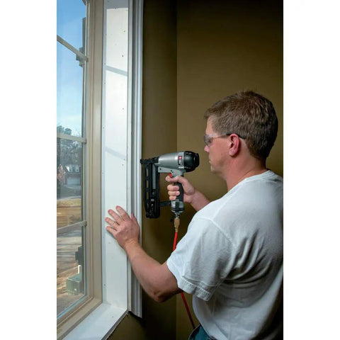 Man using 16-Gauge Straight Finish Nailer Kit With Tool-Free Depth-Of-Drive Adjustment, Jam Release, And Durable Motor on window trim