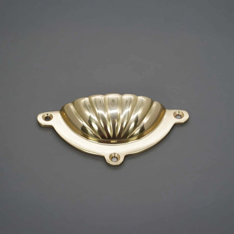 Polished Brass Cup Pull Cabinet Handle For Drawers And Doors, Cup Shell Design on gray background