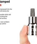 Close-up of hand holding a Torx socket from 43-Piece Drive Torx And External Star Socket Set With Rails, large stamped markings visible