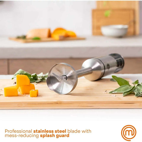 Professional Handheld Immersion Blender Featuring Powerful 400W Motor And Durable Stainless Steel Shaft Perfect For Creamy Soups Rich Sauces And Quick Daily Meal Prep Blends Effortlessly Like A Real Deal Kitchn Champion, close-up of stainless steel blending blade with splash guard on cutting board.