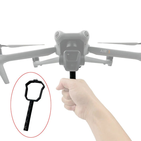 Hand holding drone handheld stabilizer and lens bracket mount for Air 3S dope one shot cinematic takeoff and landing.