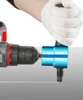 Person using Double Head Sheet Nibbler Metal Cutter for 14 gauge steel; drill attachment cutting straight line in metal sheet.