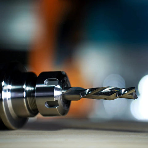 Close-up of Extra Long Four Inch Spiral Downcut Router Bit Pro Grade With Half Inch Shank in CNC collet for wood carving