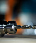 Close-up of Two Piece Down Cut Spiral Router Bit Set Pro Grade With 1/2 Inch Shank And 1/2 Inch Cutting Diameter, mounted in chuck