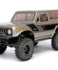 Ascent 18 Scout II Brushless 1/18 Scale RC Crawler with metal chassis, Gold Dust finish, and International Scout II body front view