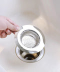 Real Heavy Hitter Stainless Steel Tub Drain Strainer And Shower Hair Catcher held above a sink, showing its design for hair trapping.
