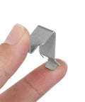 Heavy Duty Metal Shelf Clips With Super Sturdy Adjustable Mounts For Closets And Bookshelves, held between fingers.